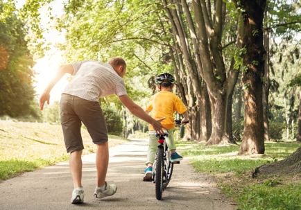 Dad and kid riding bike