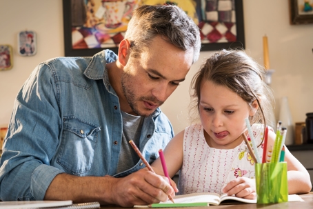 father and daughter coloring together