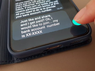 Close-up of a smartphone displaying a screenshot of text messages about sharing a bank account number, illustrating how screenshots can appear as digital evidence in criminal investigations.